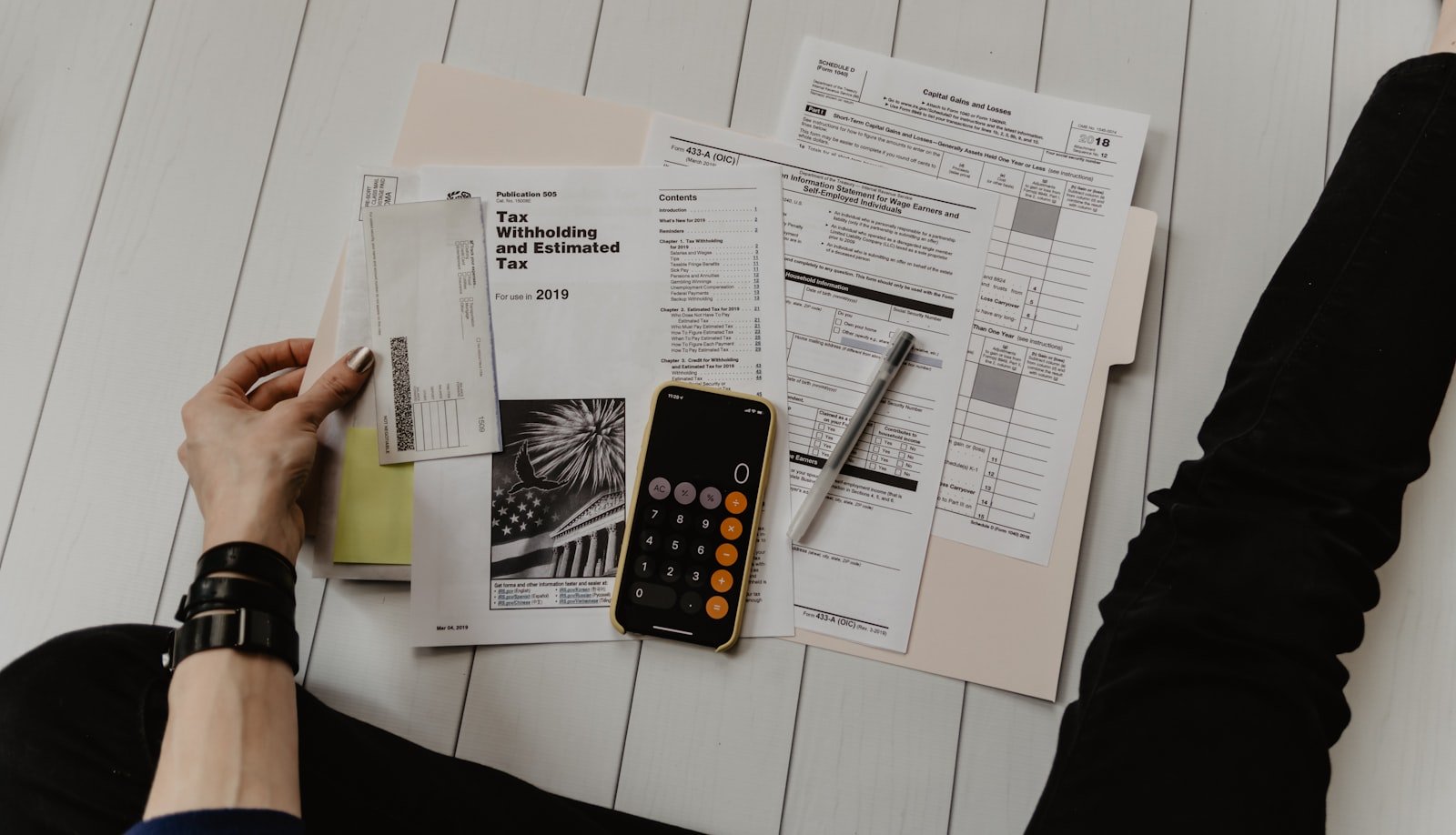 Person reviewing property paperwork with a calculator