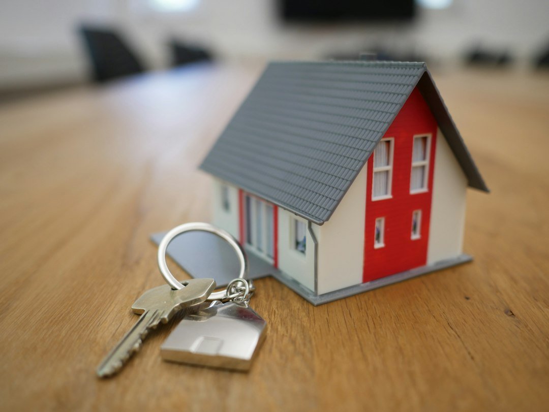 House model and keys on a table, representing home mortgages